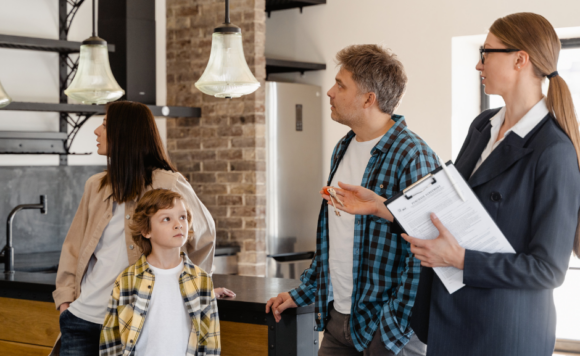 Real Estate Agent showing a family a home