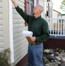 Home Inspector looking at exterior walls