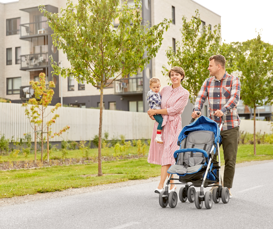 parents and kids walking along a residential street