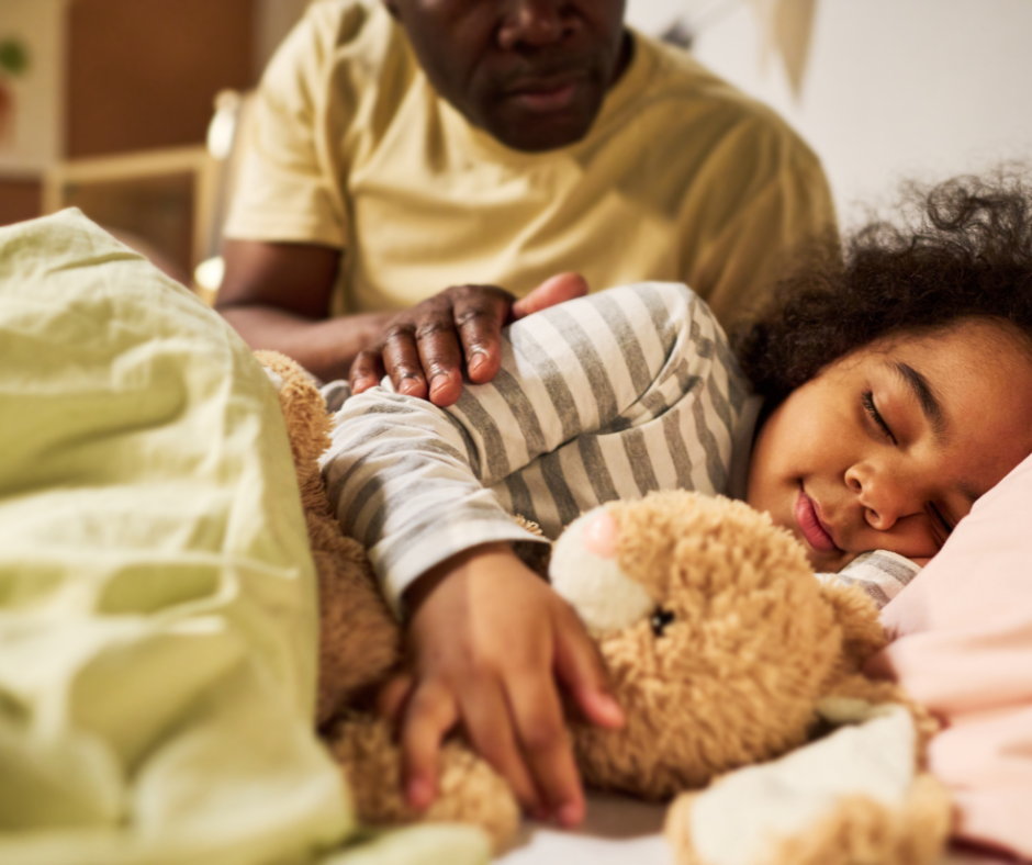 a toddler with parent putting them to bed