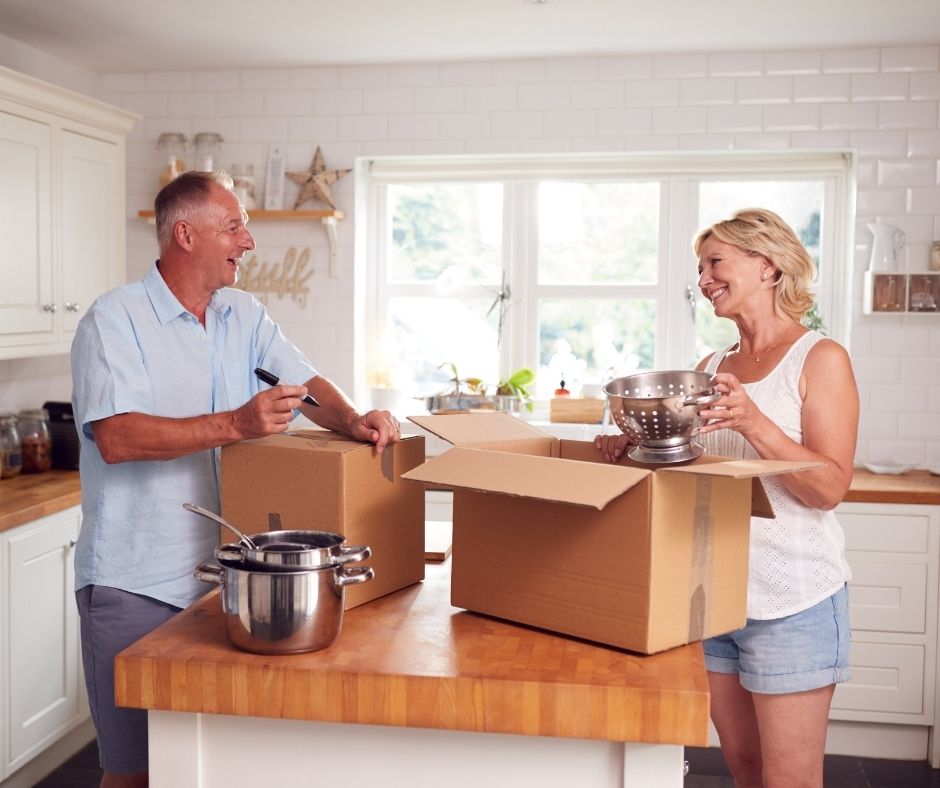 Couple packing up their kitchen getting ready to downsize
