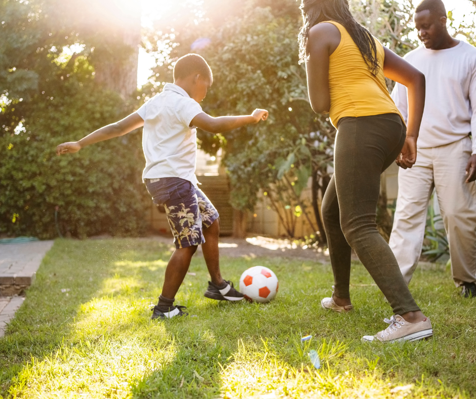 Family playing ball in backyard